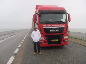 Samuel voor de vrachtwagen op de Afsluitdijk